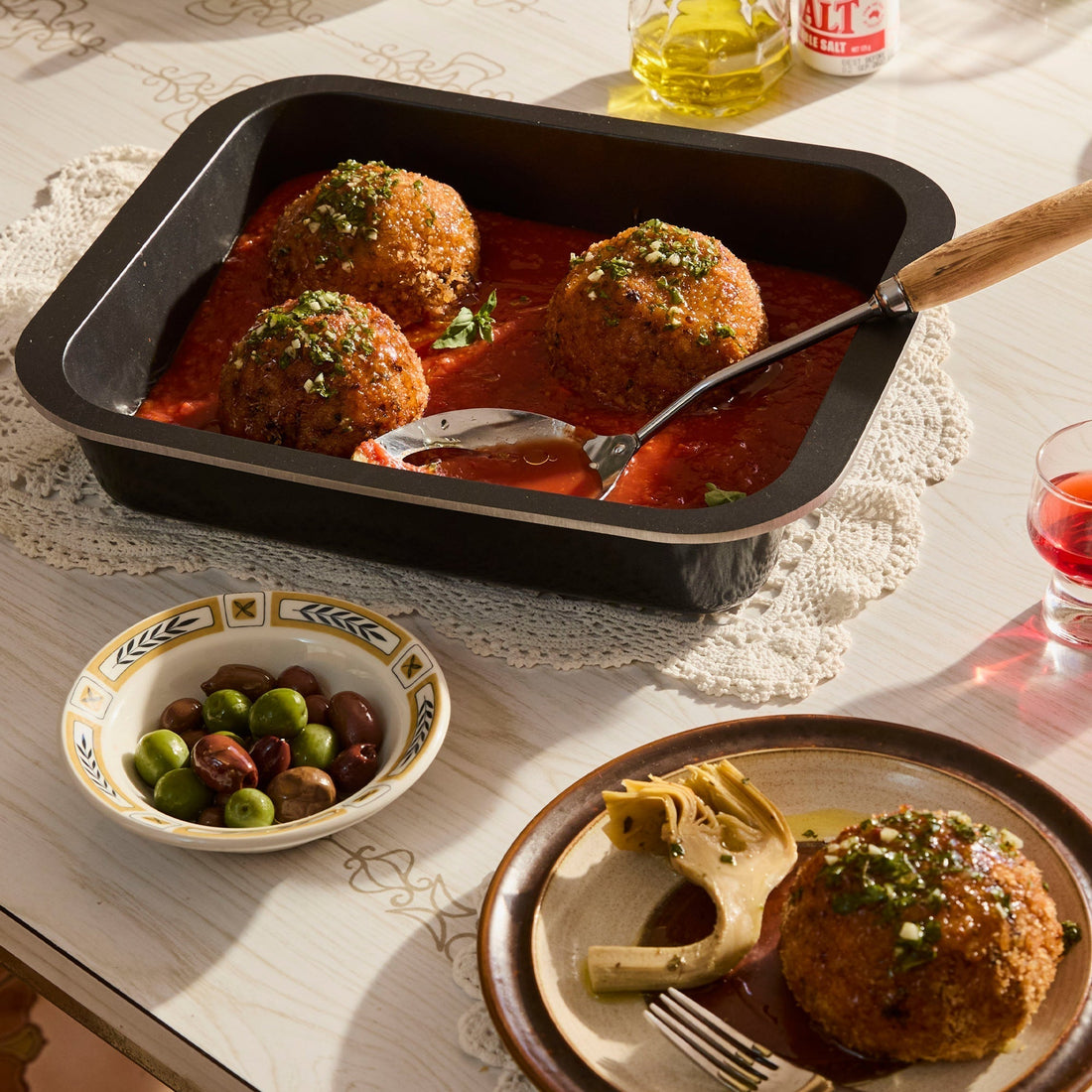 Meatballs in a black Bessemer roaster on a table