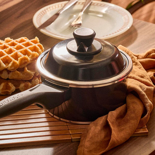 18cm black lid on saucepan sitting on a table