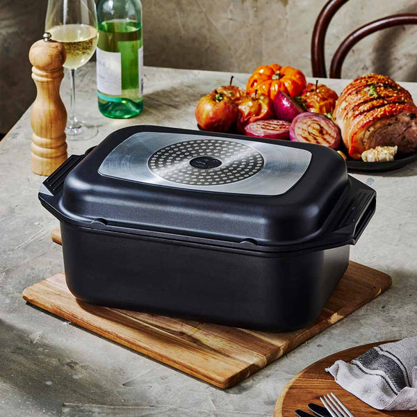 Bessemer Non Stick Roaster & Grill 34cm Black at Bessemer on a wooden board with roast pork and vegetables