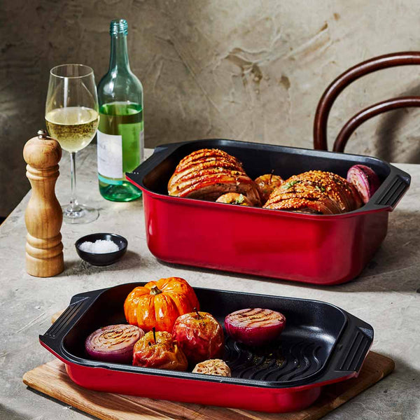 Bessemer Non Stick Roaster & Grill 34cm Red at Bessemer on a wooden board with roast pork and vegetables